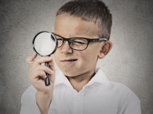 boy with magnifying glass