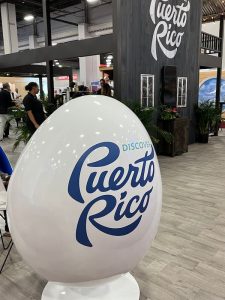 A large white egg-shaped chair displays the "Discover Puerto Rico" logo.