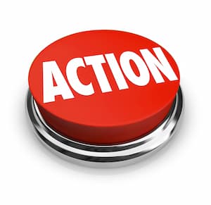 A large red button labeled “ACTION” in bold white letters, set on a metallic base, viewed from above.